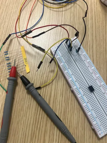 Breadboard with photodiode circuit and multimeter probes